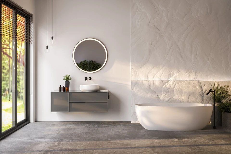 Salle de bain moderne avec baignoire îlot blanche ovale, meuble vasque suspendu gris anthracite, miroir circulaire lumineux LED