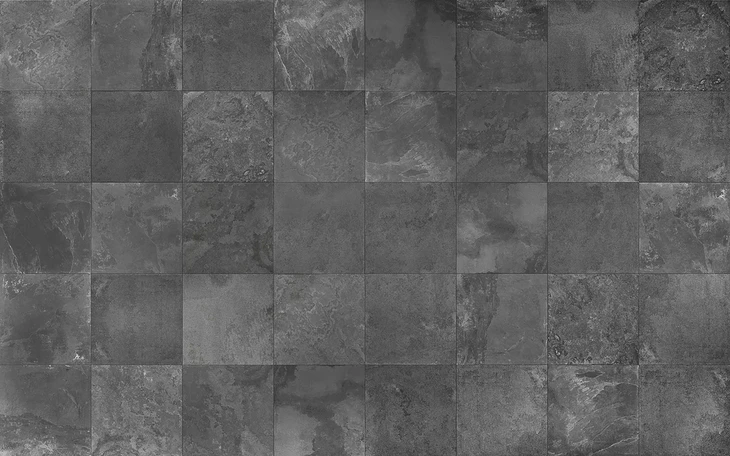 Carrelage en pierre naturelle grise disposé en damier régulier, surface murale ou sol intérieur